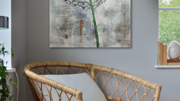 The painting of the dandelion hanging on the wall in the corner of a room.